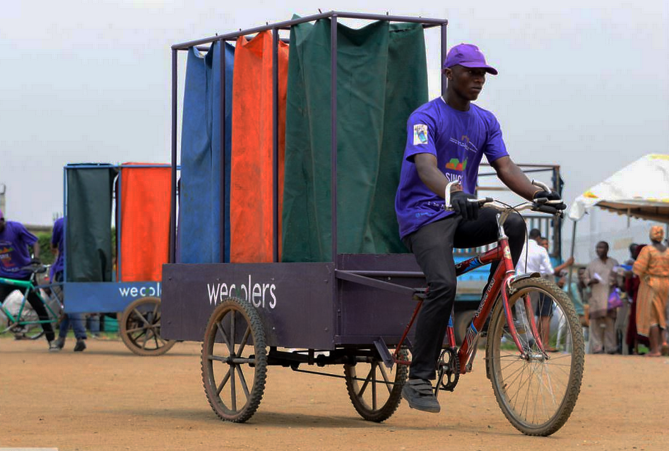 Man in Lagos, Nigeria working for WeCyclers collecting recycling from residents (2019)